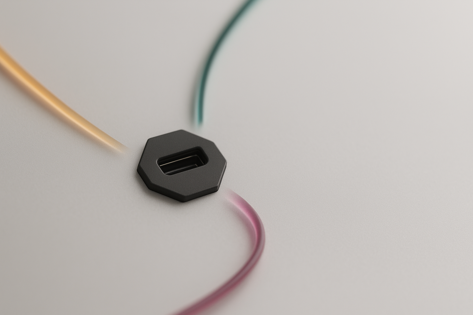 A single matte charcoal hexagonal port set into a pale grey surface, with three ribbons of coloured light approaching it from three different directions.